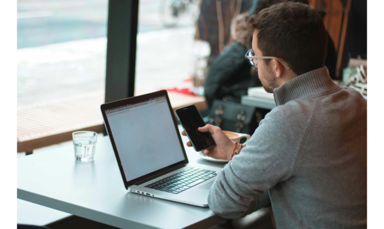 man working at coffee shop on laptop on types of freelance jobs